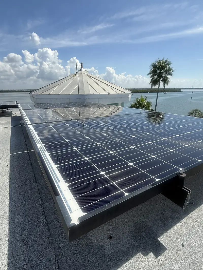 Clean solar panels overlooking the water near a cupola roof